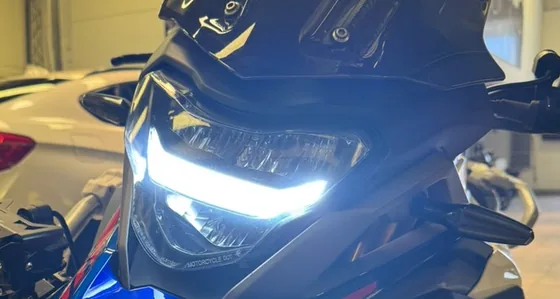 Faro LED de la BMW 310 GS 2024 encendido, con los faroles adicionales montados a los costados